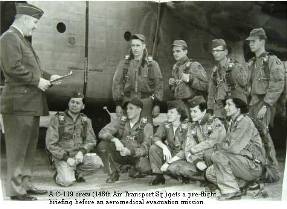 A C-119; Air Transport pre flight mission breifing in front of plane.