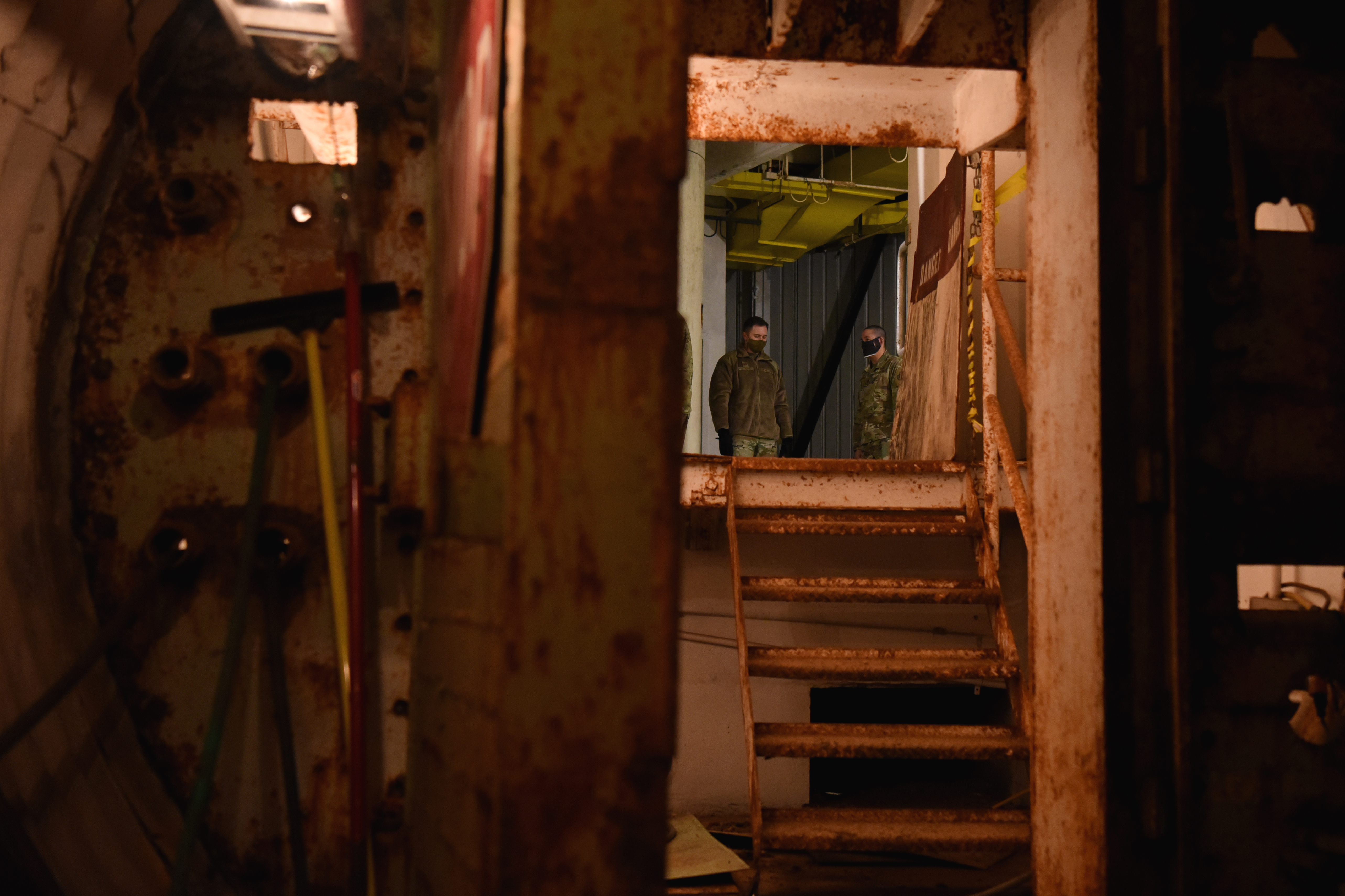 U.S. Air Force members of Goodfellow Air Force Base wait in the second floor of the launch control center for their turn to see the silo inside the underground portion of the Lawn Atlas Missile Base in Lawn, Texas, Dec 3, 2020.