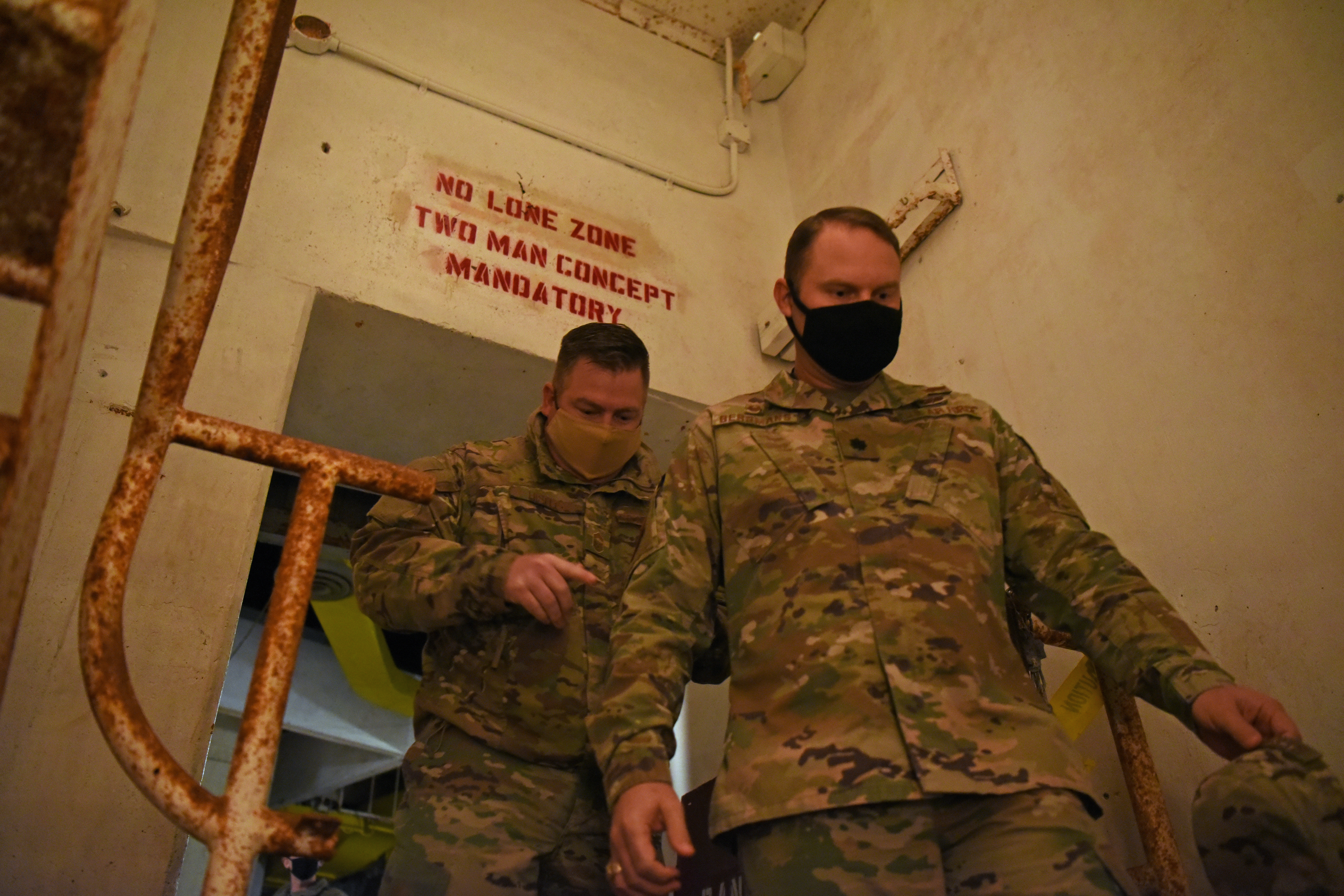 U.S. Air Force Chief Master Sgt. Toby Hiseley, 315th Training Squadron chief enlisted manager, and Lt Col. John Bergmans, 315th Training Squadron commander, descend into the Lawn Atlas Missile Base's missile tunnel to view the silo