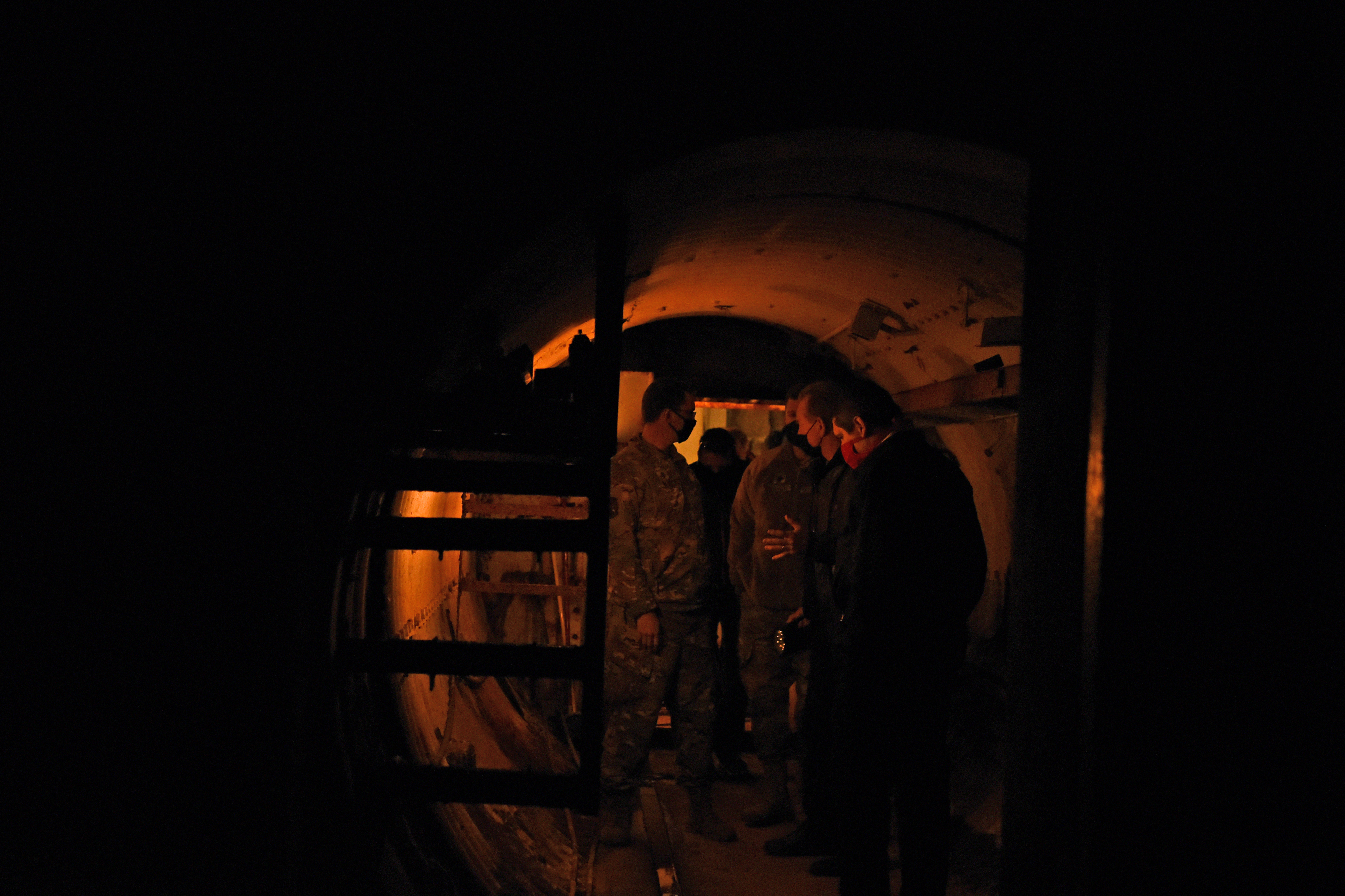 U.S. Air Force members of Goodfellow Air Force Base learn the significance of Lawn Atlas Missile Base's thick blast doors inside the tunnel on the way to the missile silo in Lawn, Texas, Dec 3, 2020.