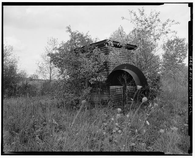 ACID STORAGE SHED, FRONT AND RIGHT SIDES, LOOKING SOUTHWEST