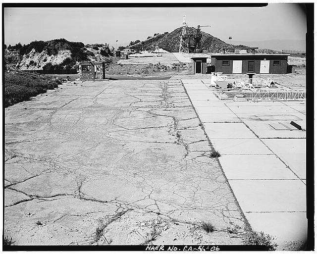 VIEW SHOWING GUARD HOUSE, STORAGE, AND TWO LAUNCH PAD UNITS, LOOKING NORTH