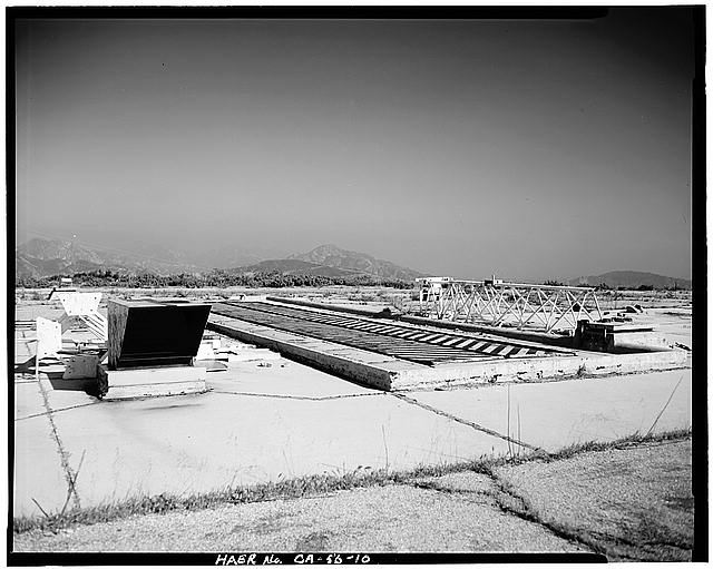 VIEW OF SILO DOORS, AIR VENTS, AND ESCAPE HATCH, LOOKING EAST. WHITE STRUCTURES BELONG TO CURRENT OCCUPANTS