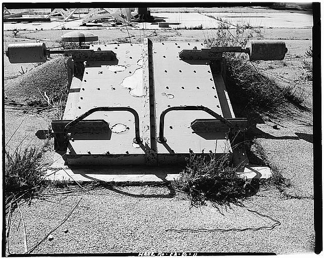 VIEW SHOWING CLOSED DOORS WITH EXPOSED COUNTERWEIGHTS, LOOKING WEST