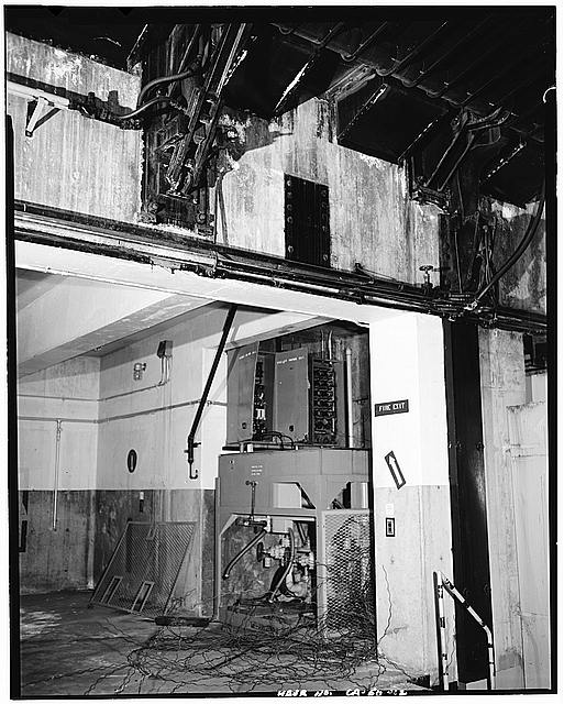 VIEW OF HYDRAULIC PUMP INSIDE SILO. ACTUATING ARMS FOR DOORS EXPOSED