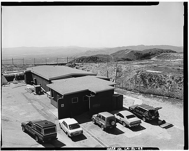 VIEW SHOWING BROWN CONCRETE BLOCK STRUCTURES AND SOUTHERN EDGE OF RADAR SITE