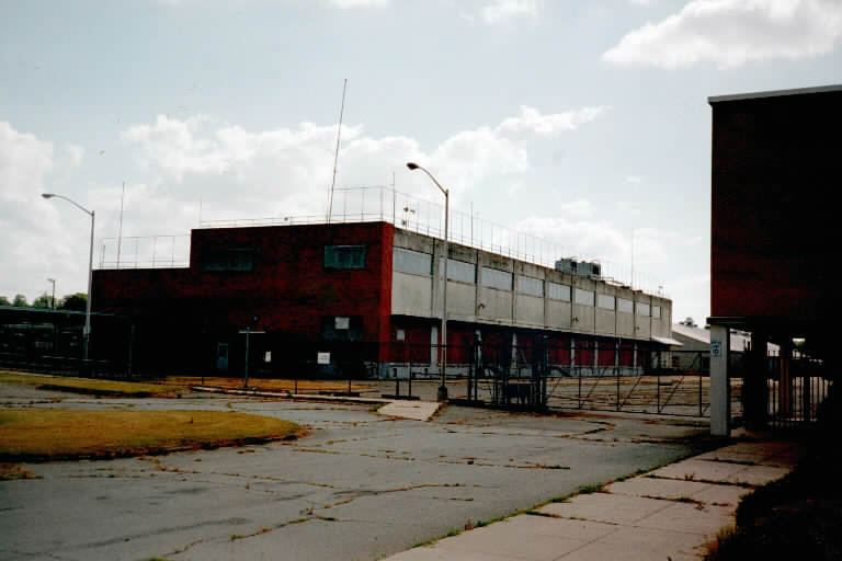 Nike Ajax Test Building. 5 or 6 systems could be tested at one time. TTR and MTR were mounted on the lower roof with a test tower (now removed) off to the levt. The LOPAR was on the upper roof. The two control trailers were located at the bricked-in openings on the ground level right. There were two large elevators at the rear to each of the roofs.