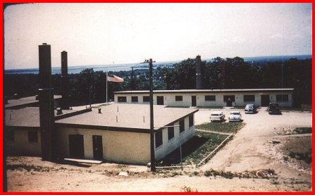 1957. Barracks, BOQ in foreground, Administration building in back and on the left of the
flag is the Mess hall. 