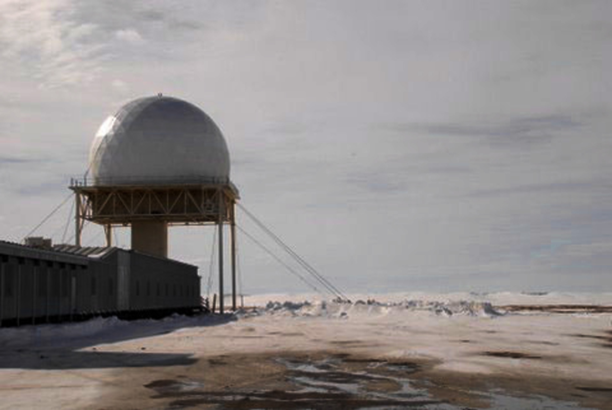 Barter Island radar radome and connected support building in snow beside the Beaufort Sea in 2009