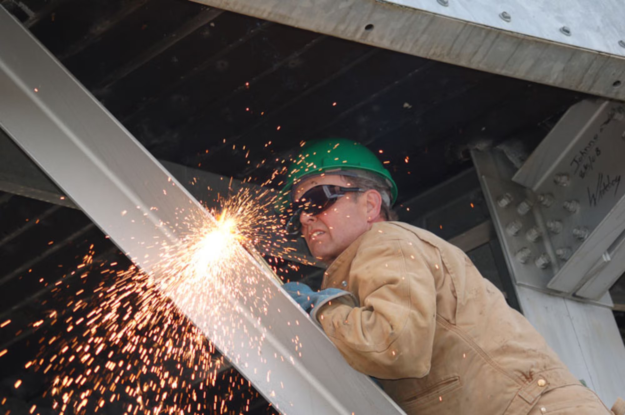 Worker cutting steel support of Bethel White Alice antenna in 2011