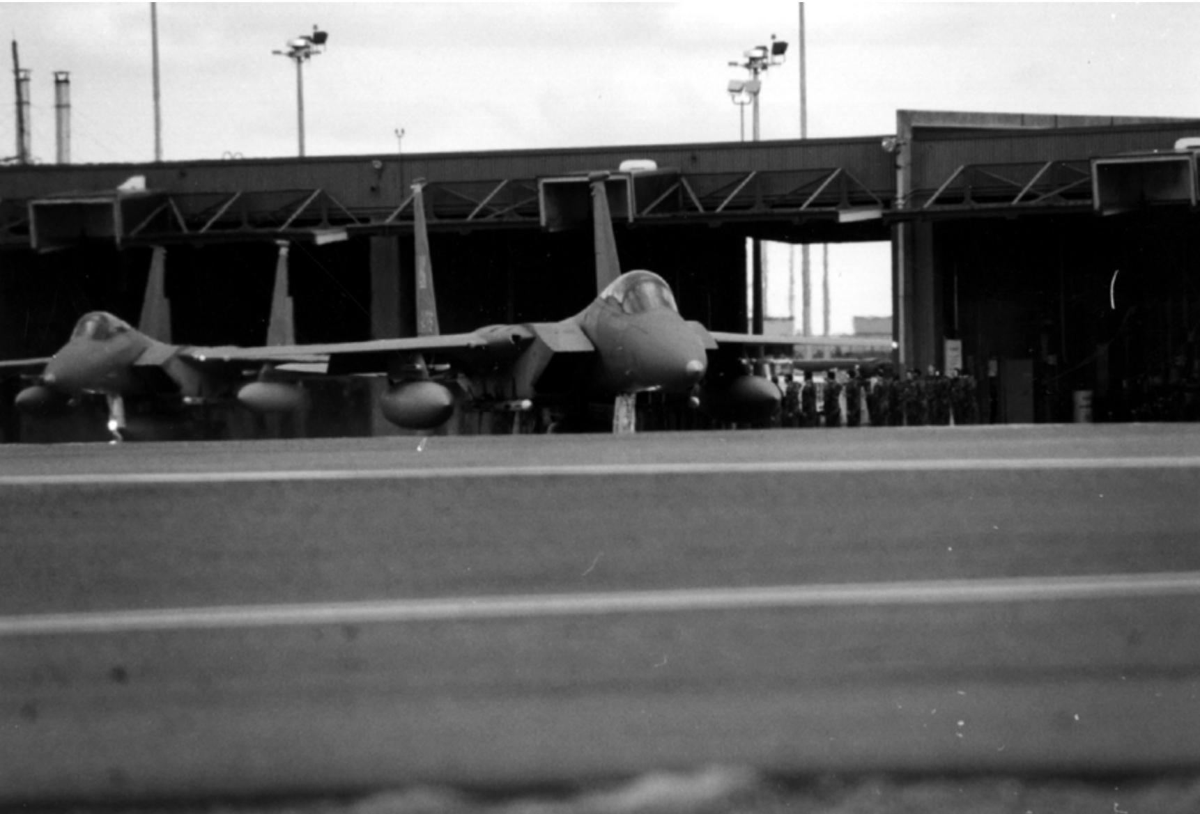 Two F-15 fighters at King Salmon Airport with the Combat Alert Cell behind them, undated