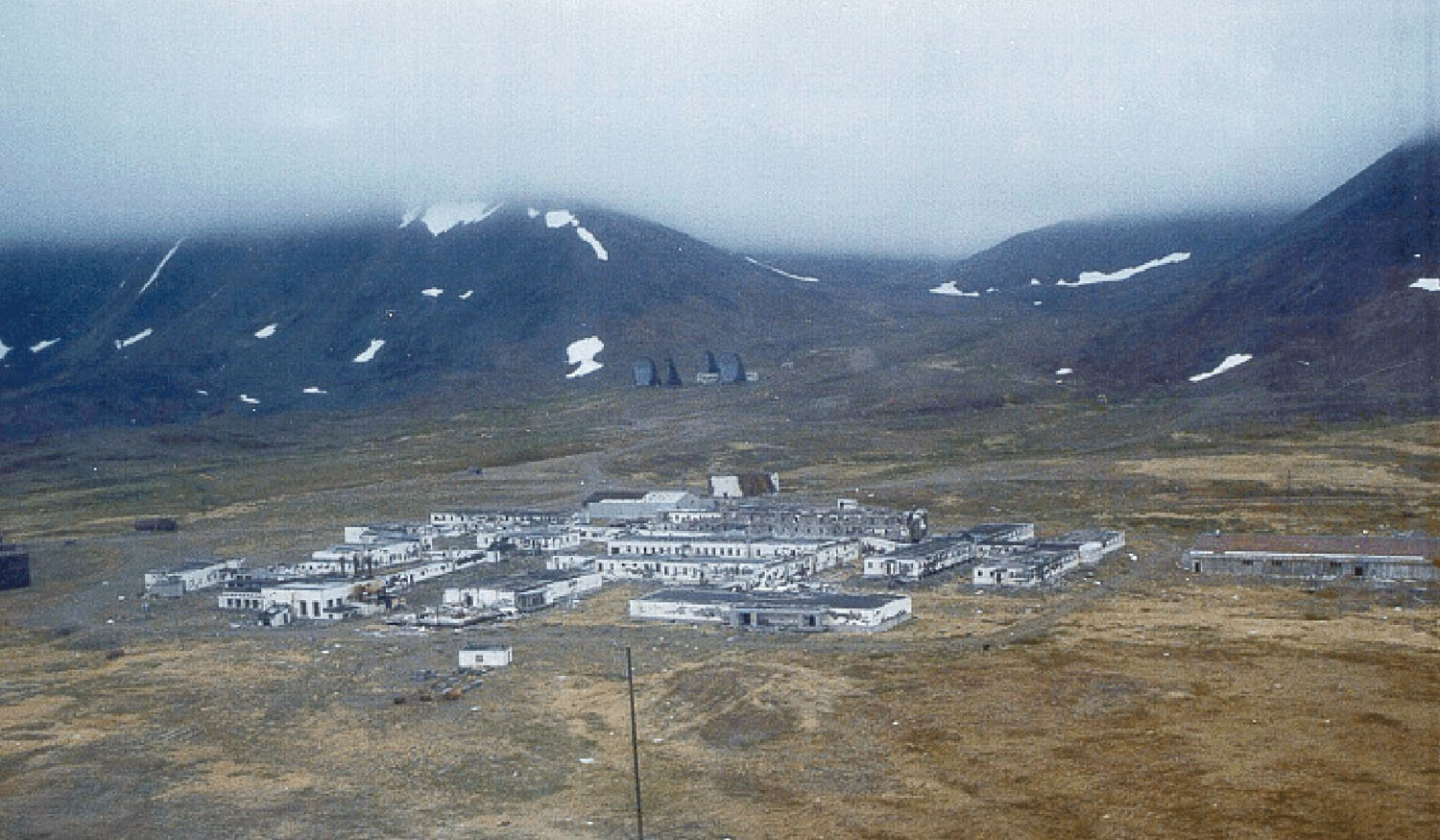 1999 U.S. Army Corps photograph showing four Northeast Cape White Alice antennas uphill behind the former radar station