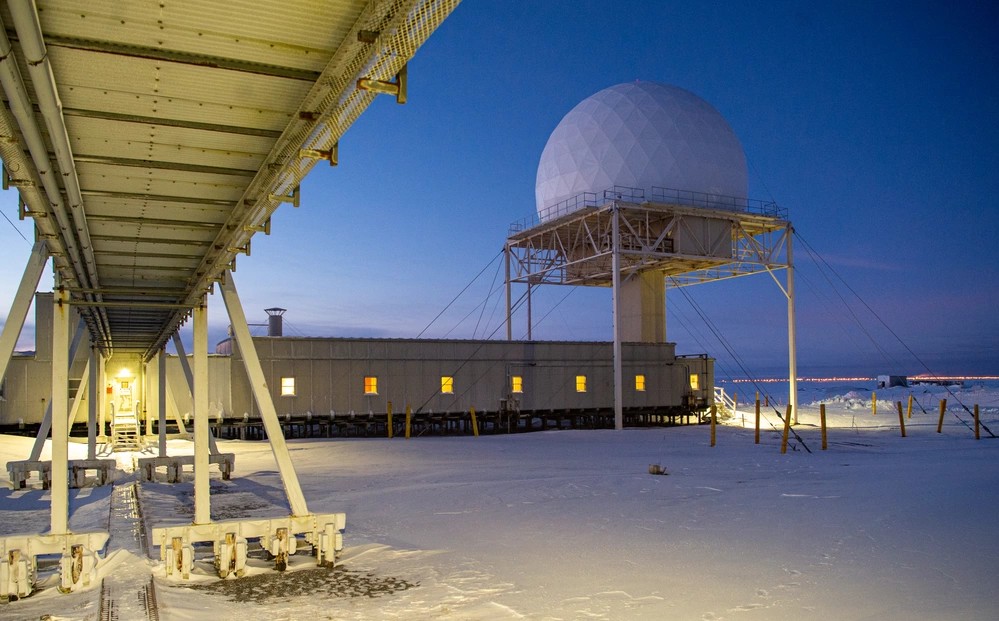 Point Barrow Long Range Radar Site at dawn in 2023, with elevated radome and connected station buildings amid snow