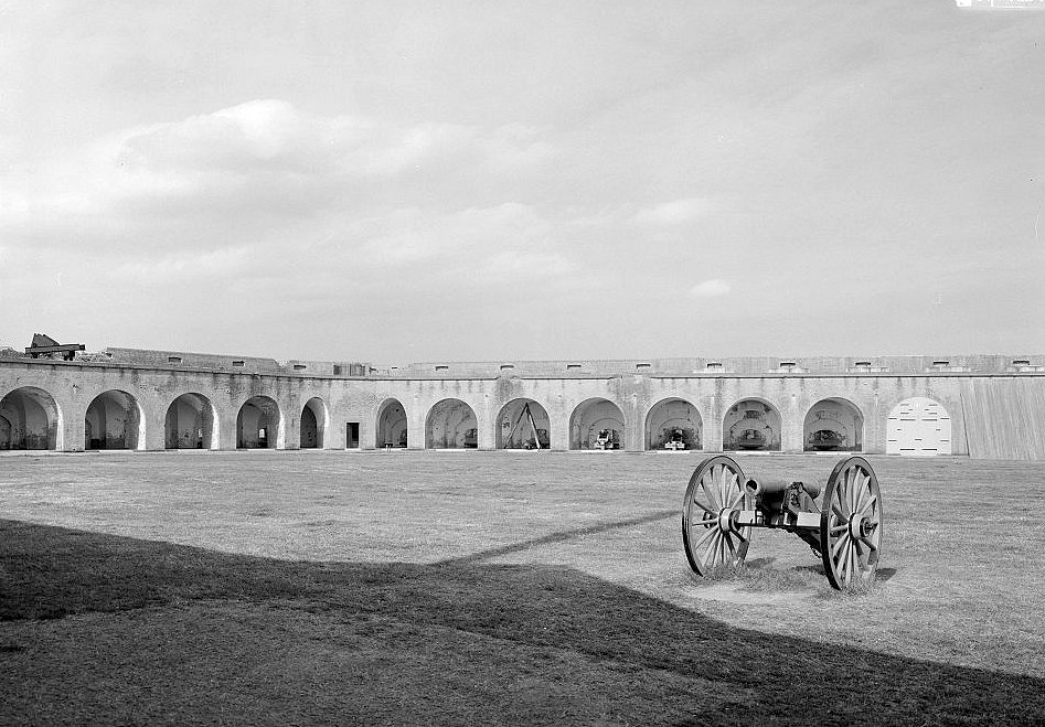 View of Parade Ground inside Fort Looking to the Northeast Generally So That Part of the North Wall Is Visible as Well as the First 8 Bays of the Northeast Wall (Note: Cannon in Foreground and Shadow of Flagpole above Gorge Wall)