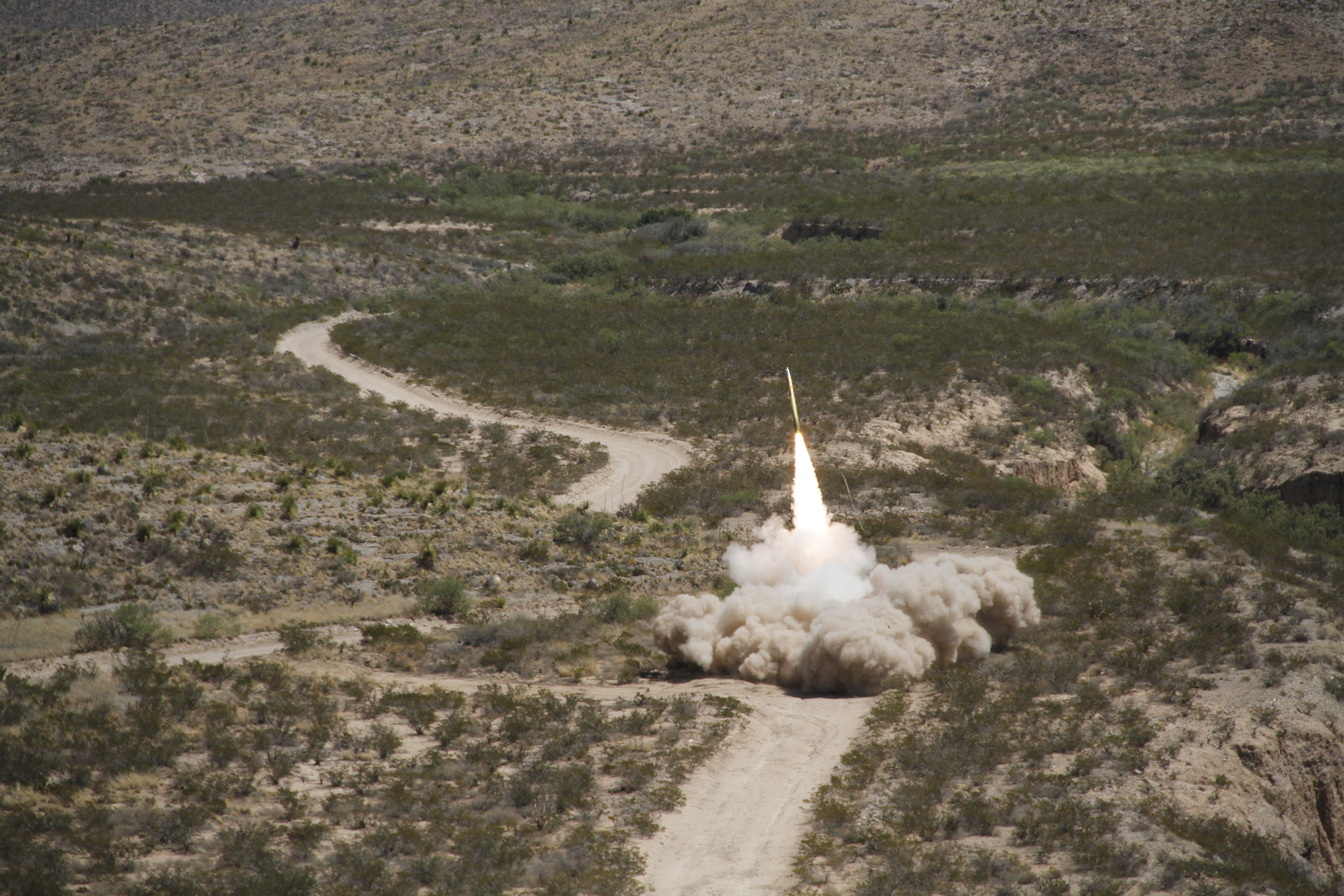 A guided multiple launch rocket system (GMLRS) rocket is launched from a High-Mobility Artillery Rocket System, mounted on a truck, during exercise Iron Rage at McGregor Range