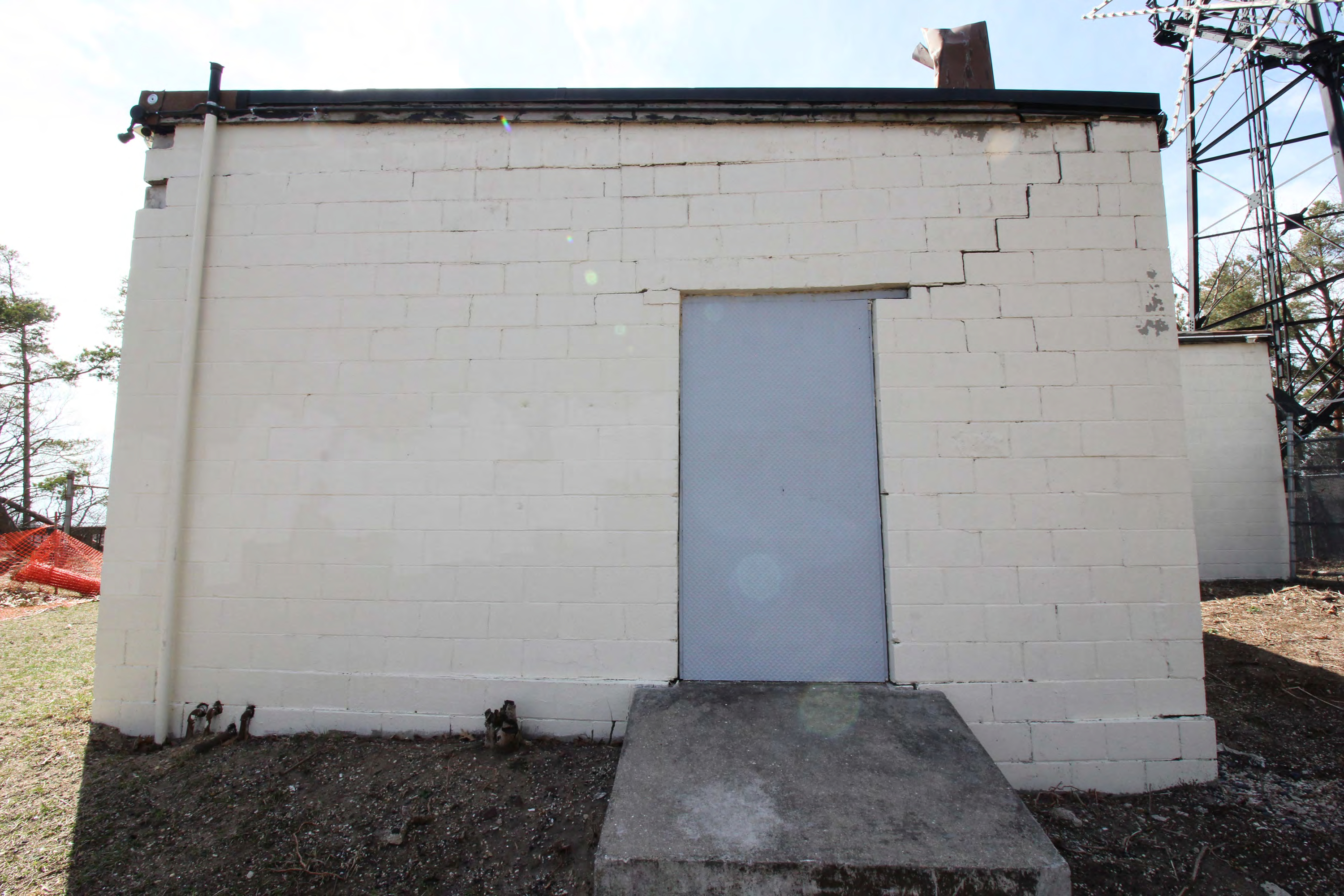 Generator room east exterior wall and door, from east.