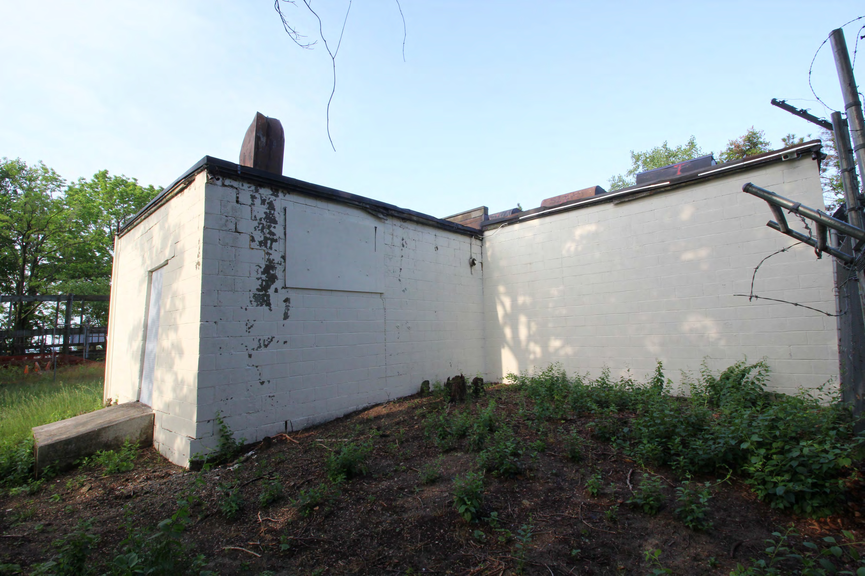 Generator room north and equipment room east exterior walls, from northeast.