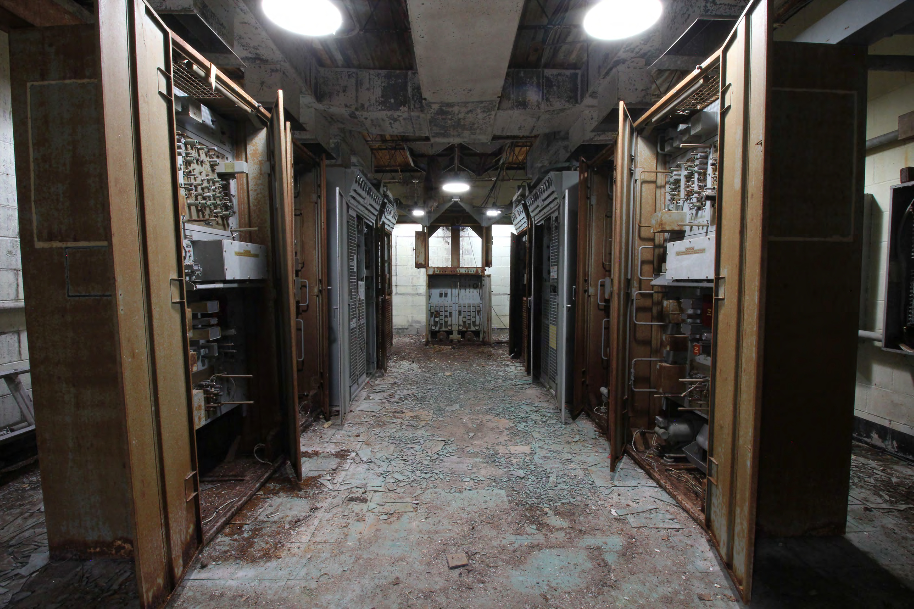 Equipment room, two rows of redundant FPS-18 radar equipment Cabinets, A-Channel on right, B-Channel on left, with receivers closest, FPS-18 control monitor-near far north wall, from south. 